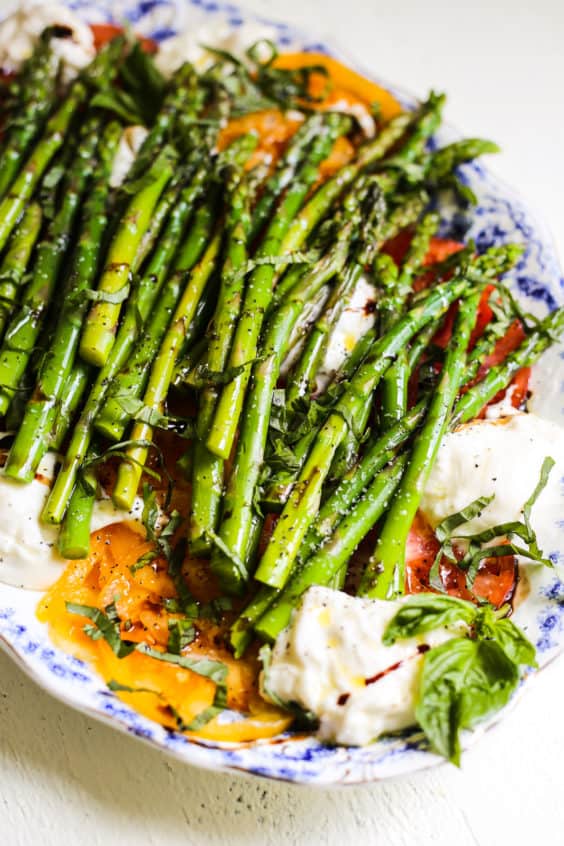 asparagus and tomato caprese salad with burrata and herbs