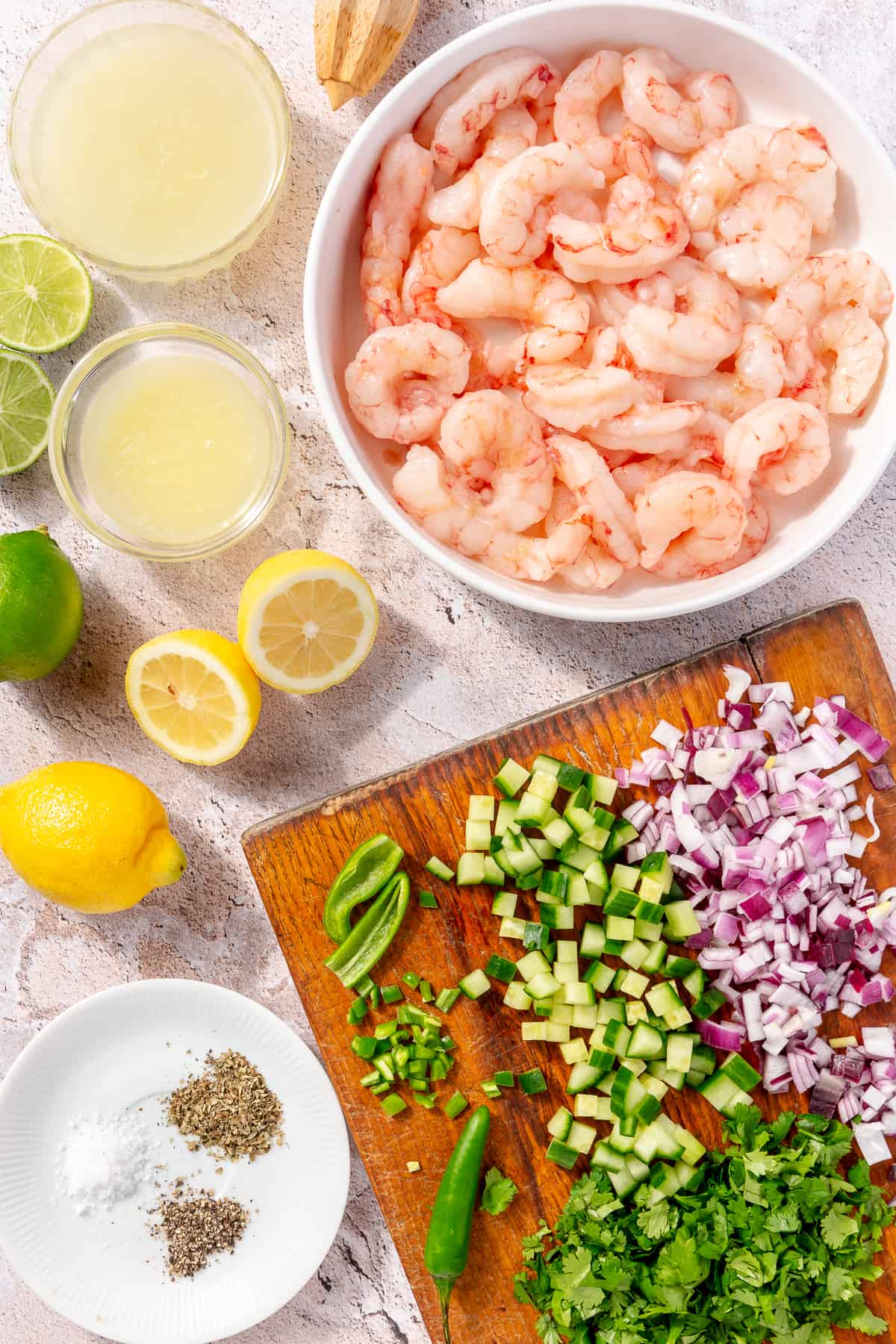 Shrimp Ceviche ingredients on counter in bowls and on cutting boards.