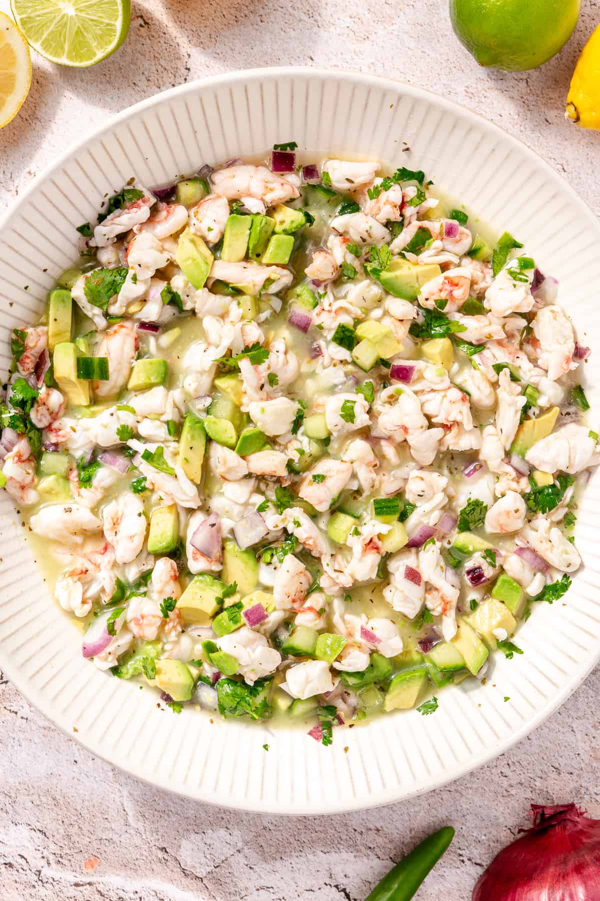 Shrimp Ceviche in large white bowl with diced avocado.