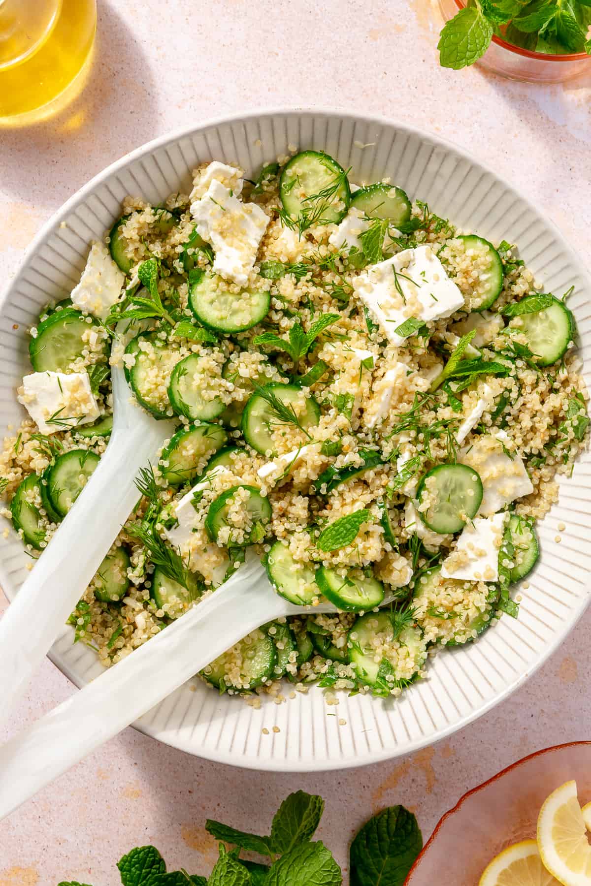 Quinoa salad tossed with all ingredients in large bowl.