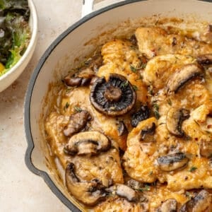 Close up of Whole30 Chicken Marsala in a white skillet.