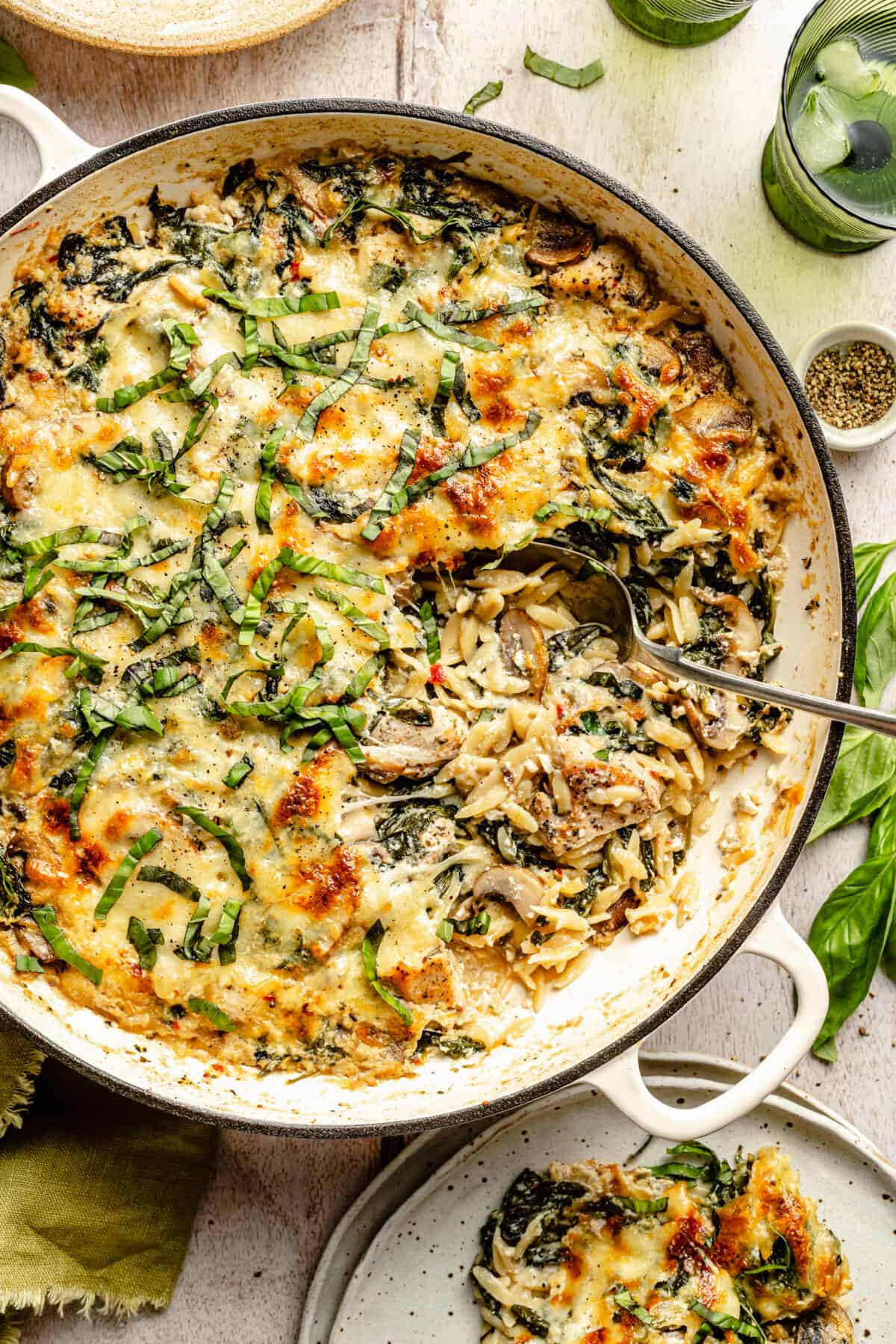 Creamy Ricotta Chicken and Orzo Skillet with spoon in it scooping it out.