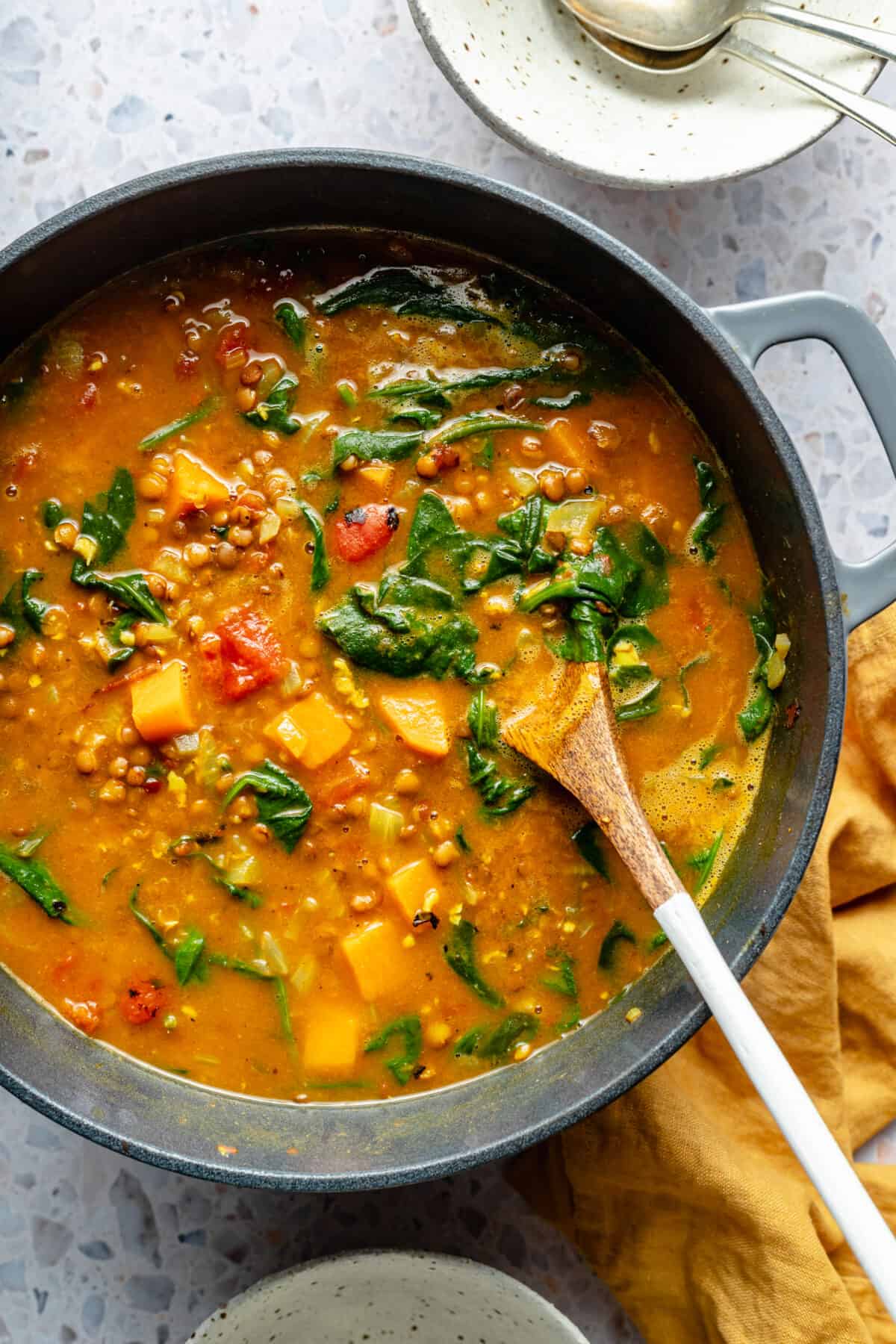 Large pot of Curried Lentil Soup with spinach in it. 
