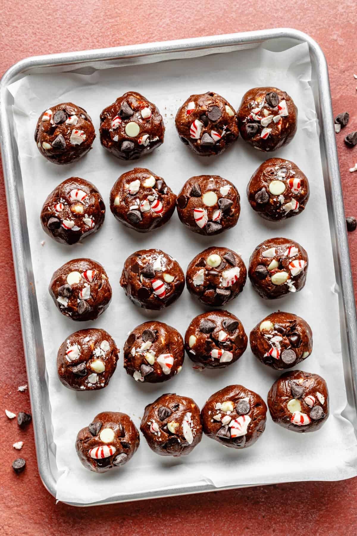 Double Chocolate Peppermint Cookie dough rolled into balls on sheet pan.