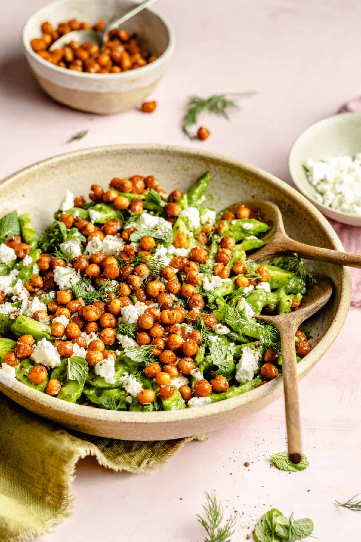 Cucumber Salad with Crispy Chickpeas in a large bowl with serving utensils.