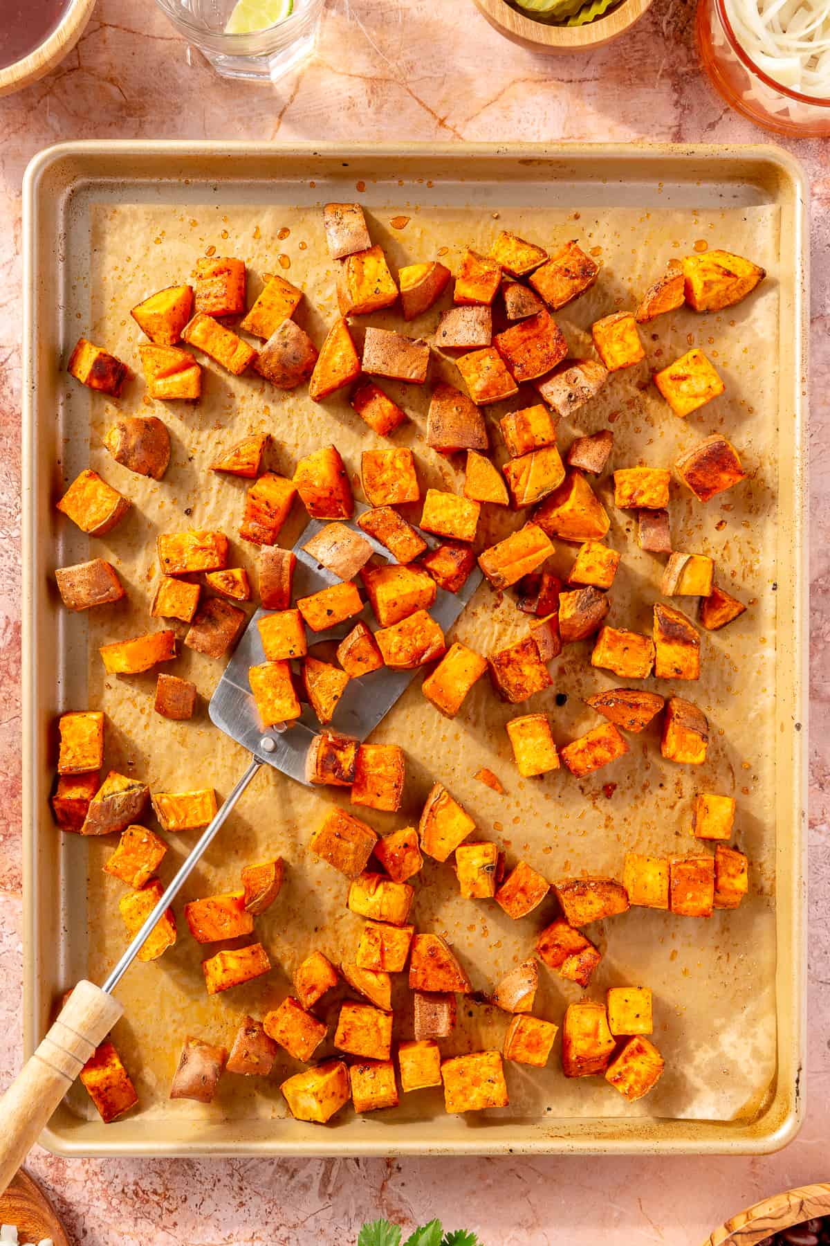 Diced, crispy sweet potatoes on sheet pan.