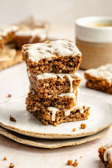 Three Iced Oatmeal Cookie Bars stacked on plate.