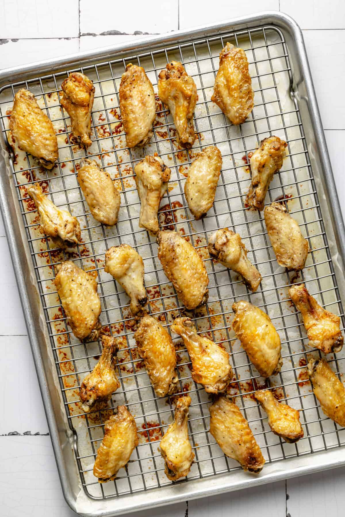 Crispy chicken wings on wire rack. Not coated in sauce yet.
