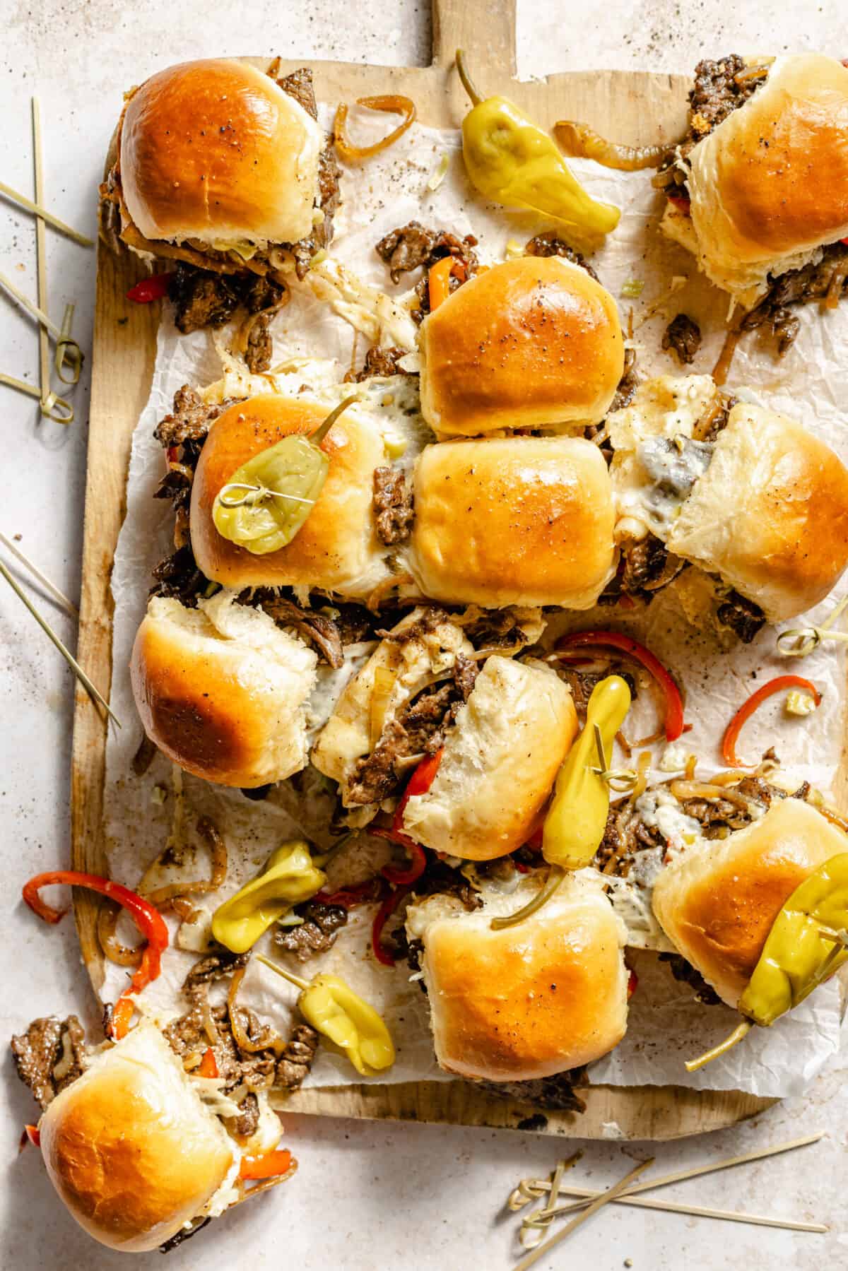 Philly Cheesesteak Sliders sliced and on cutting board.
