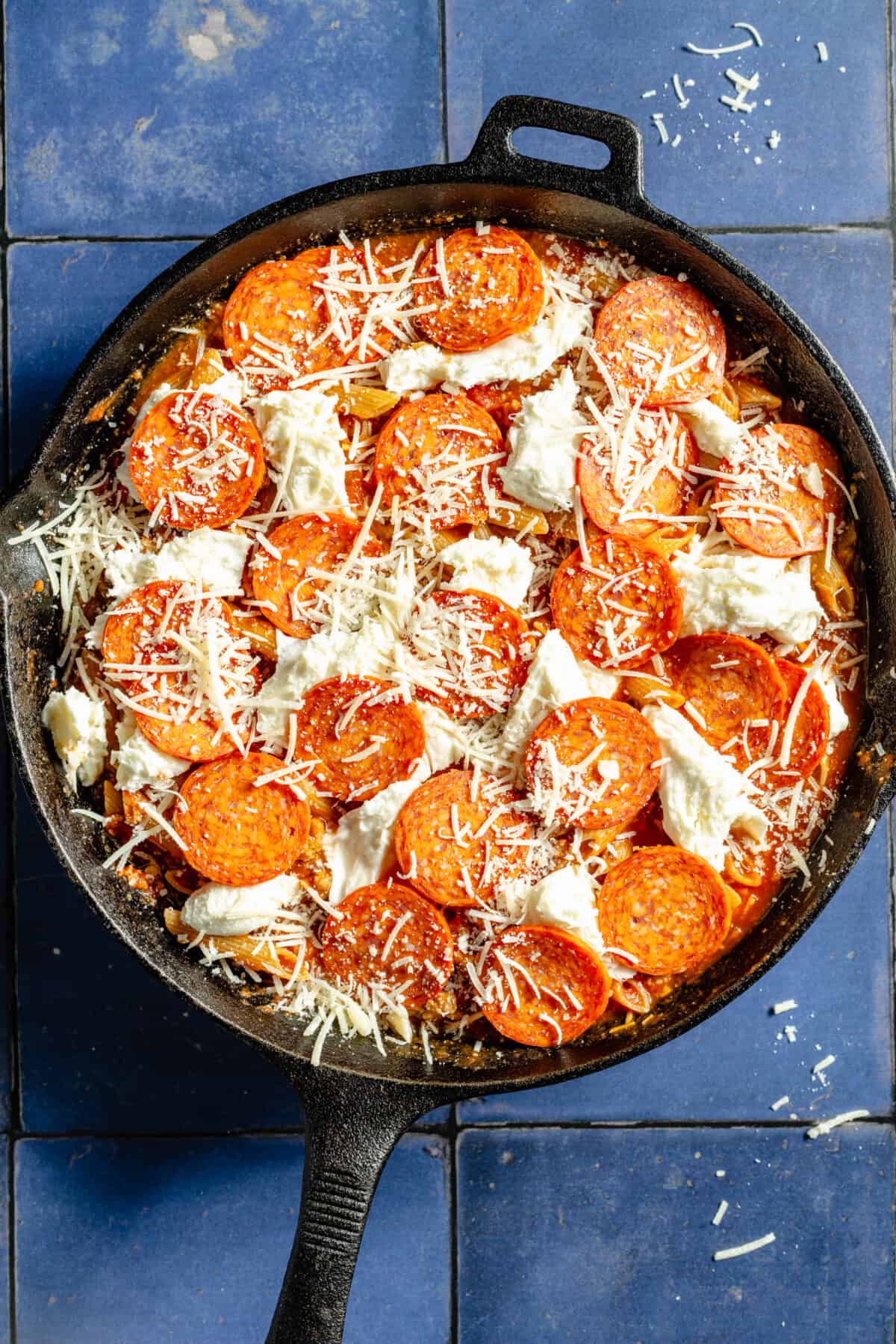 Skillet Pizza Penne with raw pepperoni and cheese on top before cooking.