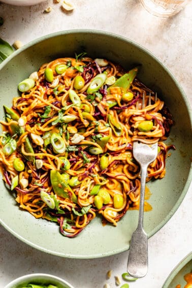 Gochujang and Peanut Veggie Noodles in green bowl with fork.