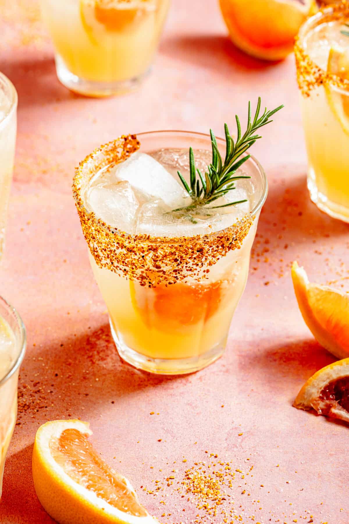 Skinny Rosemary Paloma in low glass with grapefruit and rosemary garnish.