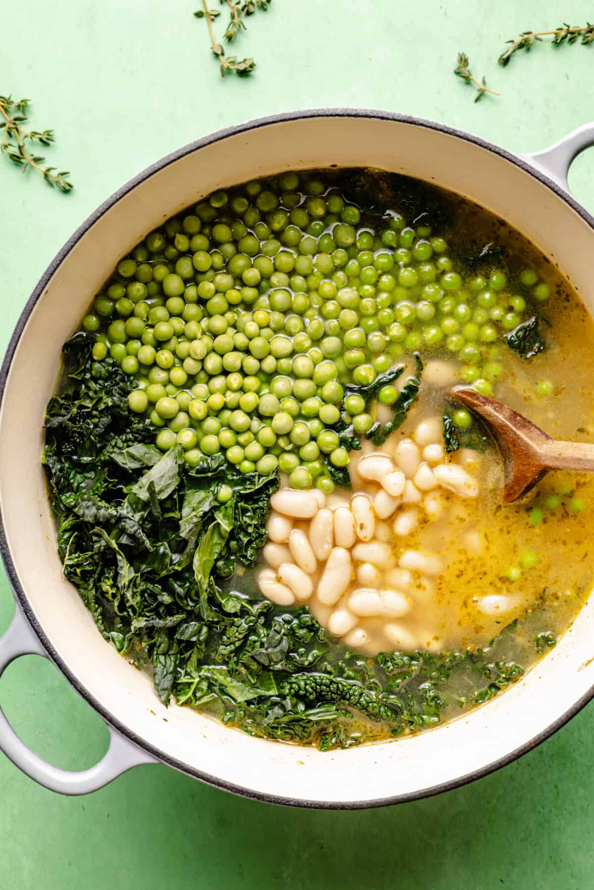 Spring Green Minestrone with greens, peas and beans not stirred together yet.
