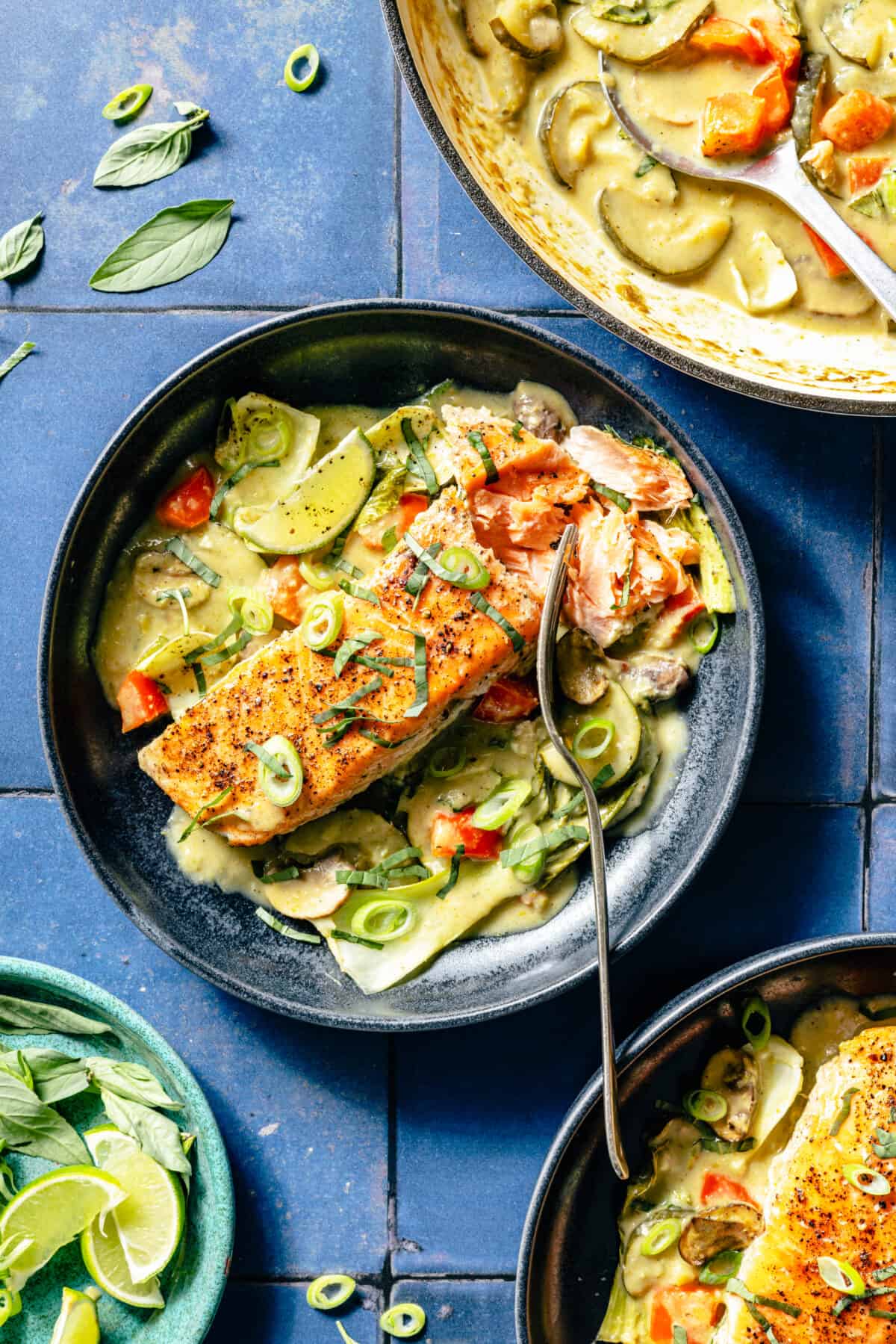 Thai-Inspired Coconut Green Curry Salmon plated in blue bowl.