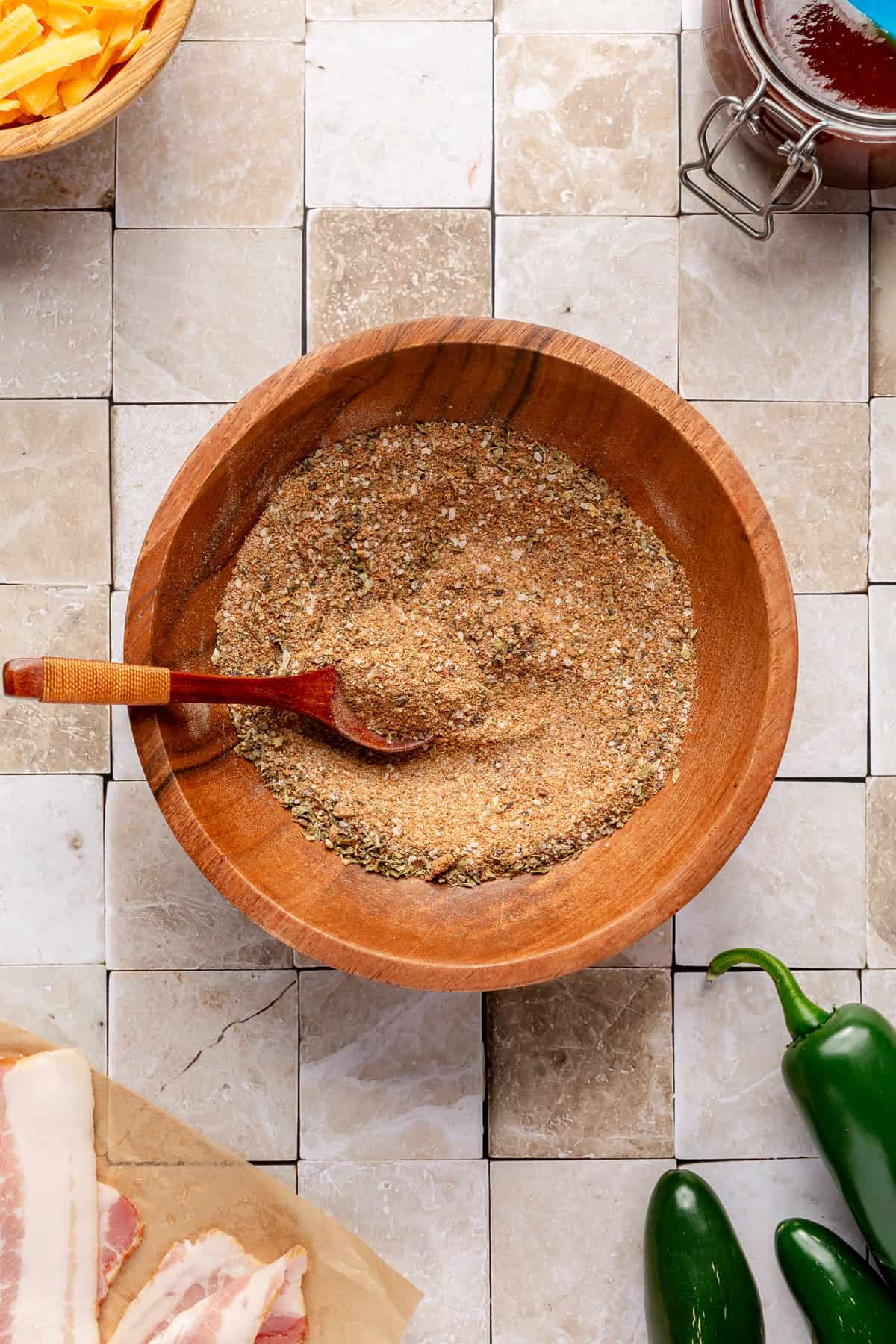 Seasoning rub for Grilled Jalapeño Popper Chicken in a small wooden bowl.