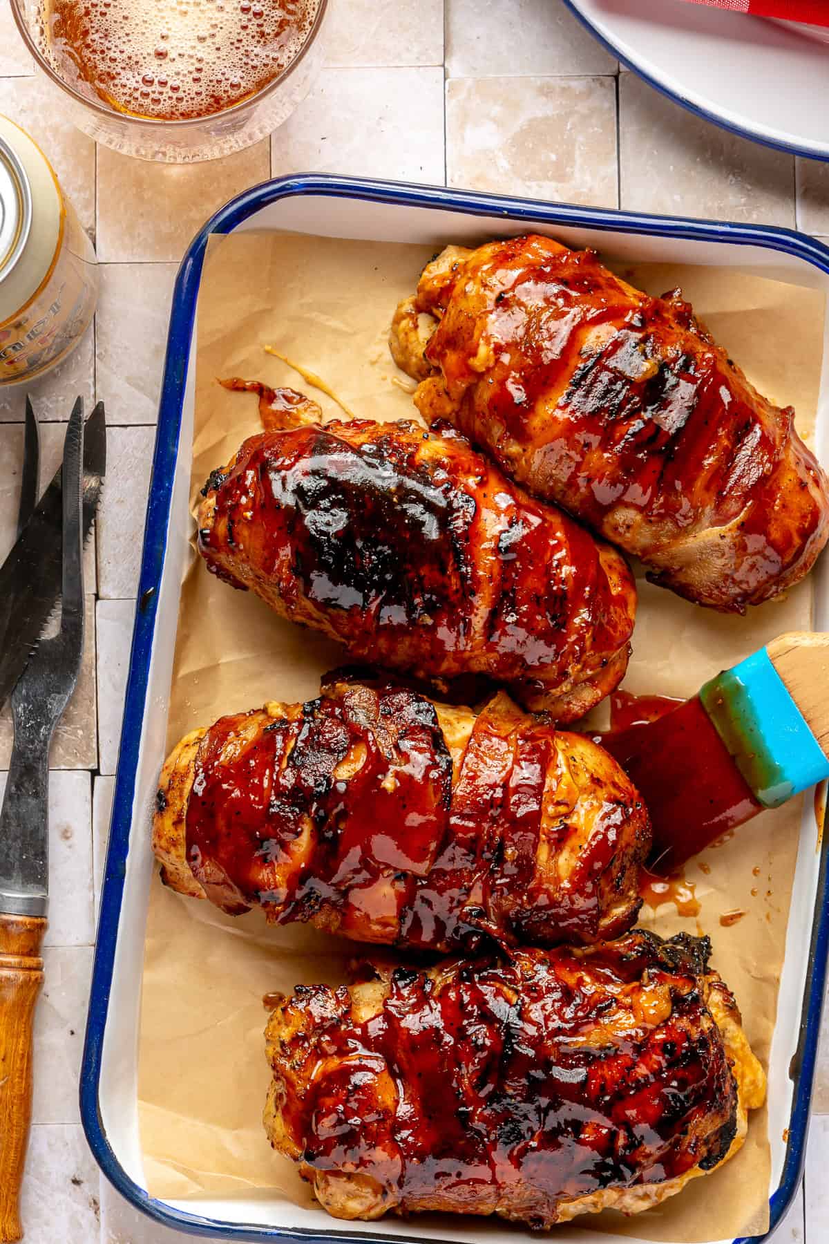 Bacon-wrapped chicken basted with BBQ sauce.