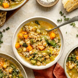 a few bowls of chickpea and farro soup with fresh thyme and a torn baguette