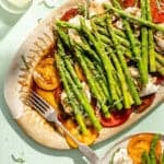 an up-close photo of asparagus caprese salad on a large platter