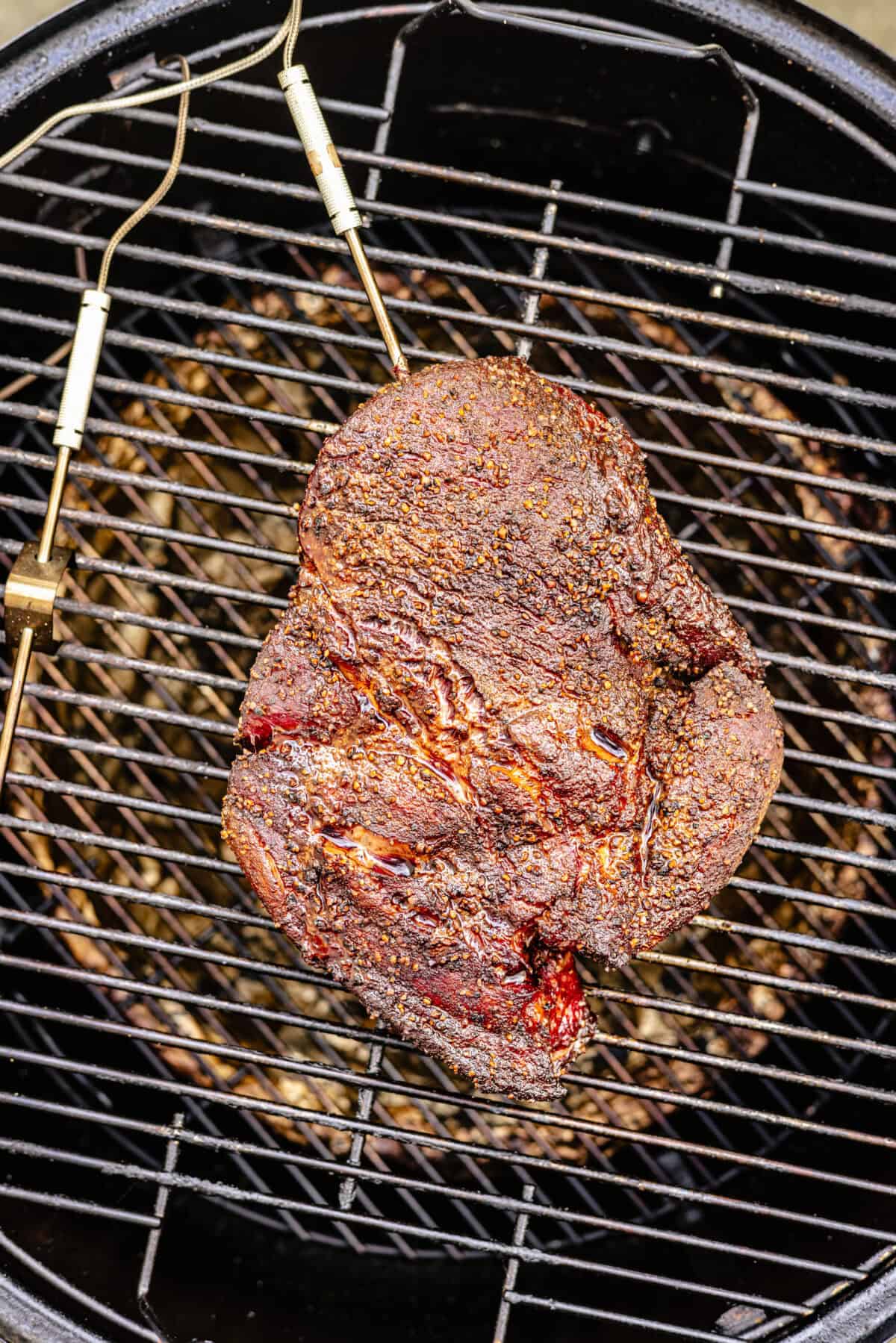 chuck roast on a wire rack set in a smoker