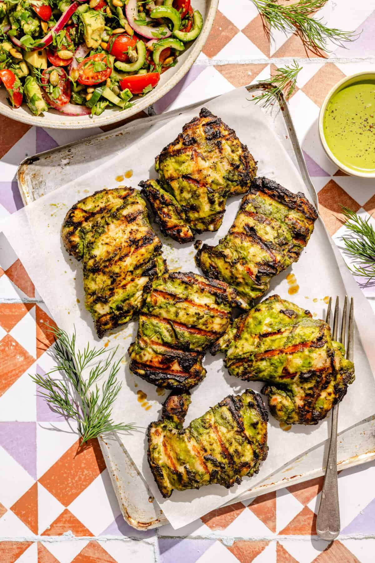 grilled green goddess chicken thighs on a platter