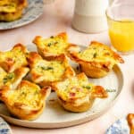 mini ham and cheese quiches on a stoneware platter
