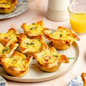 mini ham and cheese quiches on a stoneware platter