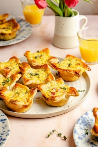 mini ham and cheese quiches on a stoneware platter