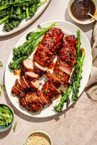 a white platter of grilled and glazed pork tenderloins
