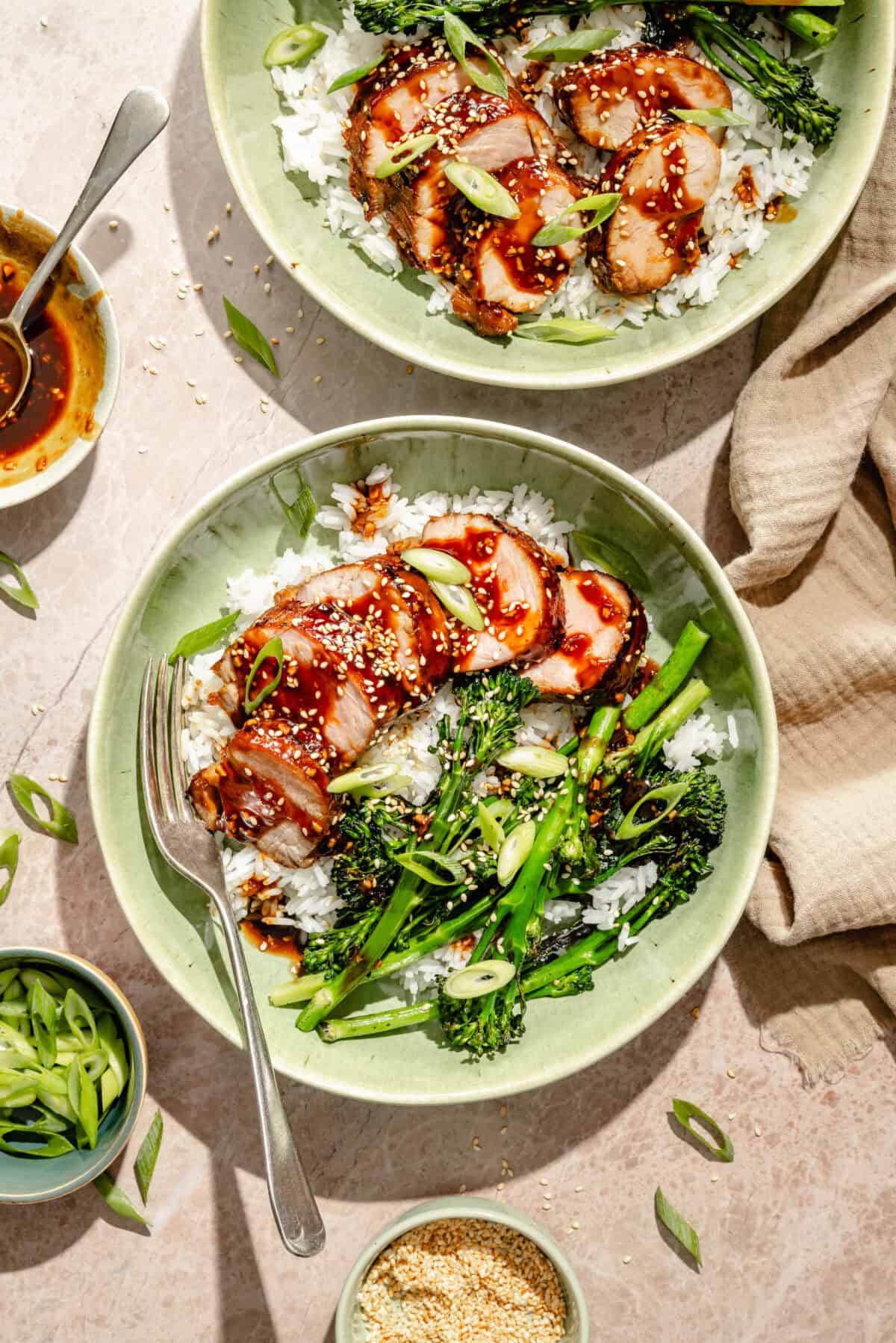 bowls of glazed and grilled pork tenderloin over rice with broccoli