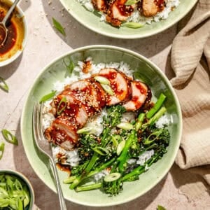 bowls of glazed and grilled pork tenderloin over rice with broccoli