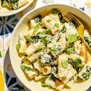 Creamy Lemon Pasta with Ricotta and Basil in a bowl on a tiled surface.