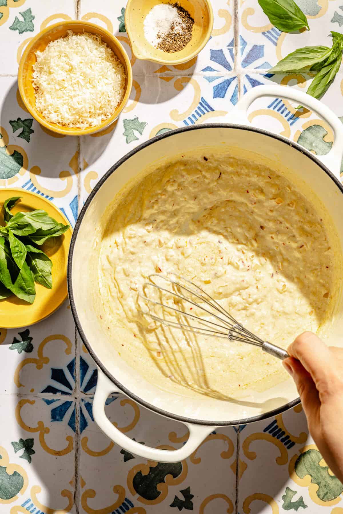 Creamy Lemon Pasta with Ricotta and Basil sauce getting whisked in pot.
