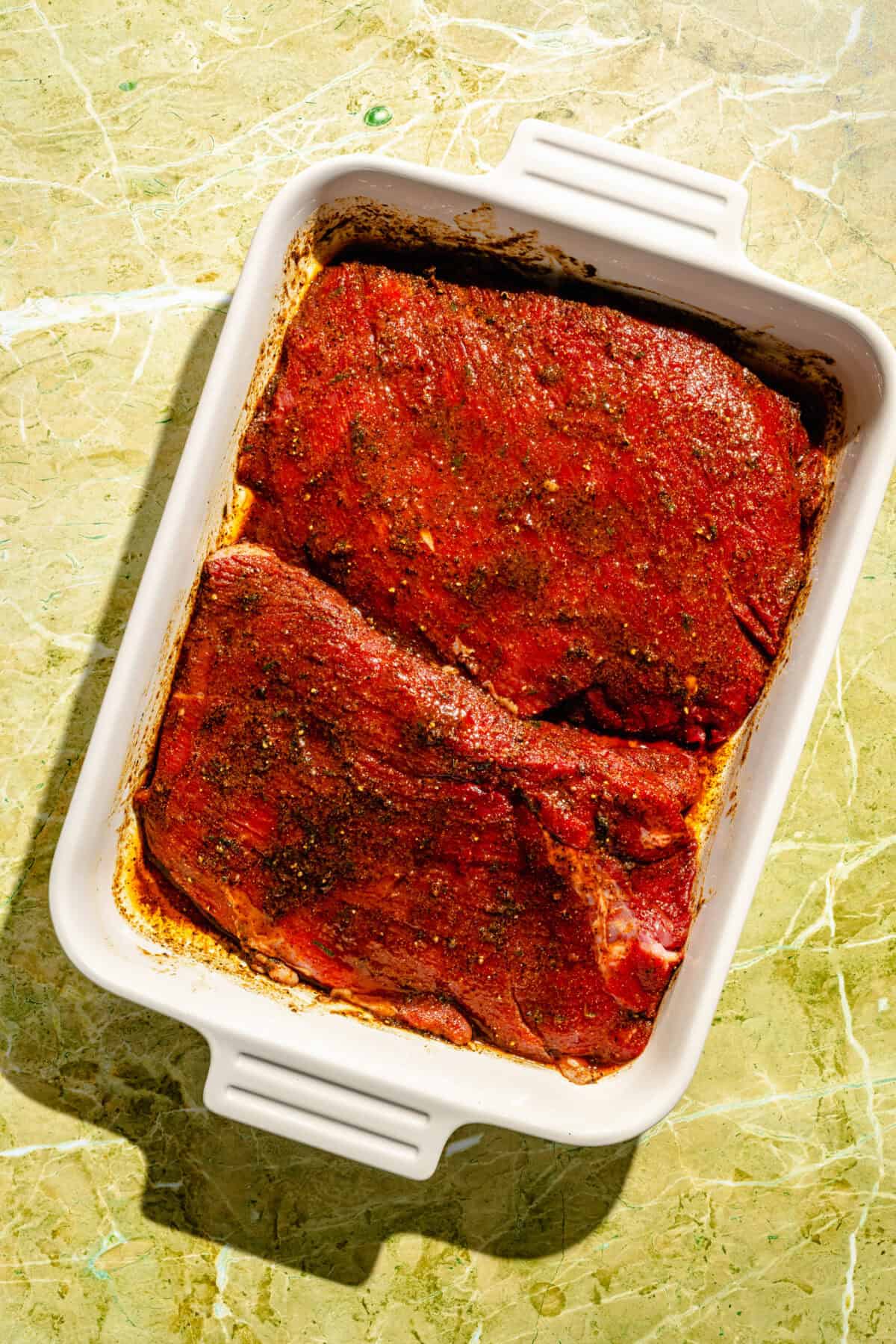 Flap Steak marinating in baking dish.