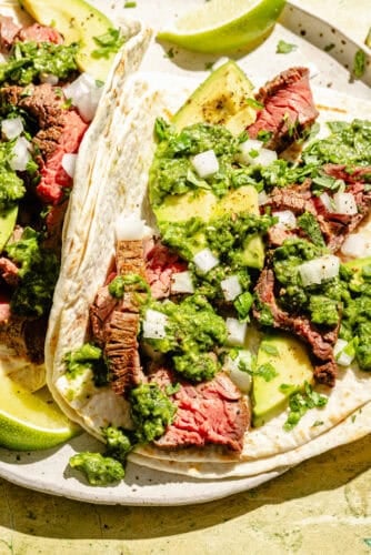 Two Flap Steak Tacos with Jalapeño Chimichurri assembled on a plate.