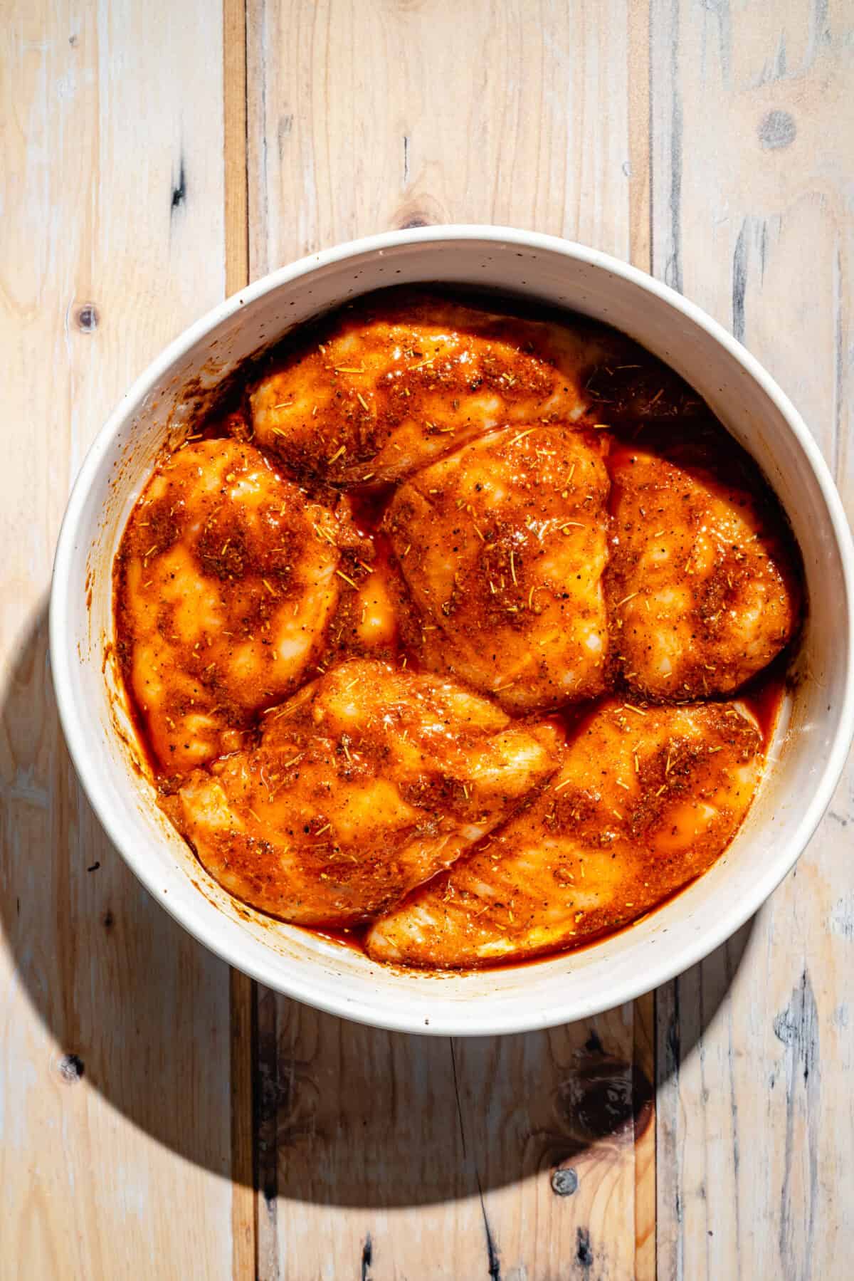Cajun Chicken marinating in bowl.