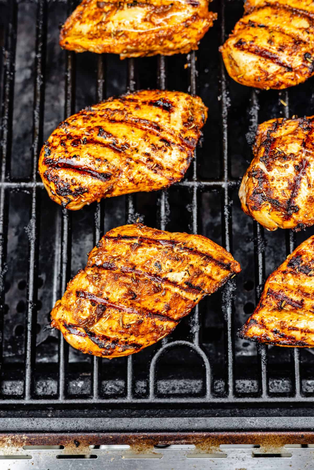 Cajun Chicken cooking on grill.