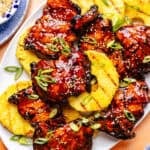 Huli Huli–Inspired Chicken on platter with grilled pineapple slices.