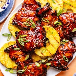 Huli Huli–Inspired Chicken on platter with grilled pineapple slices.