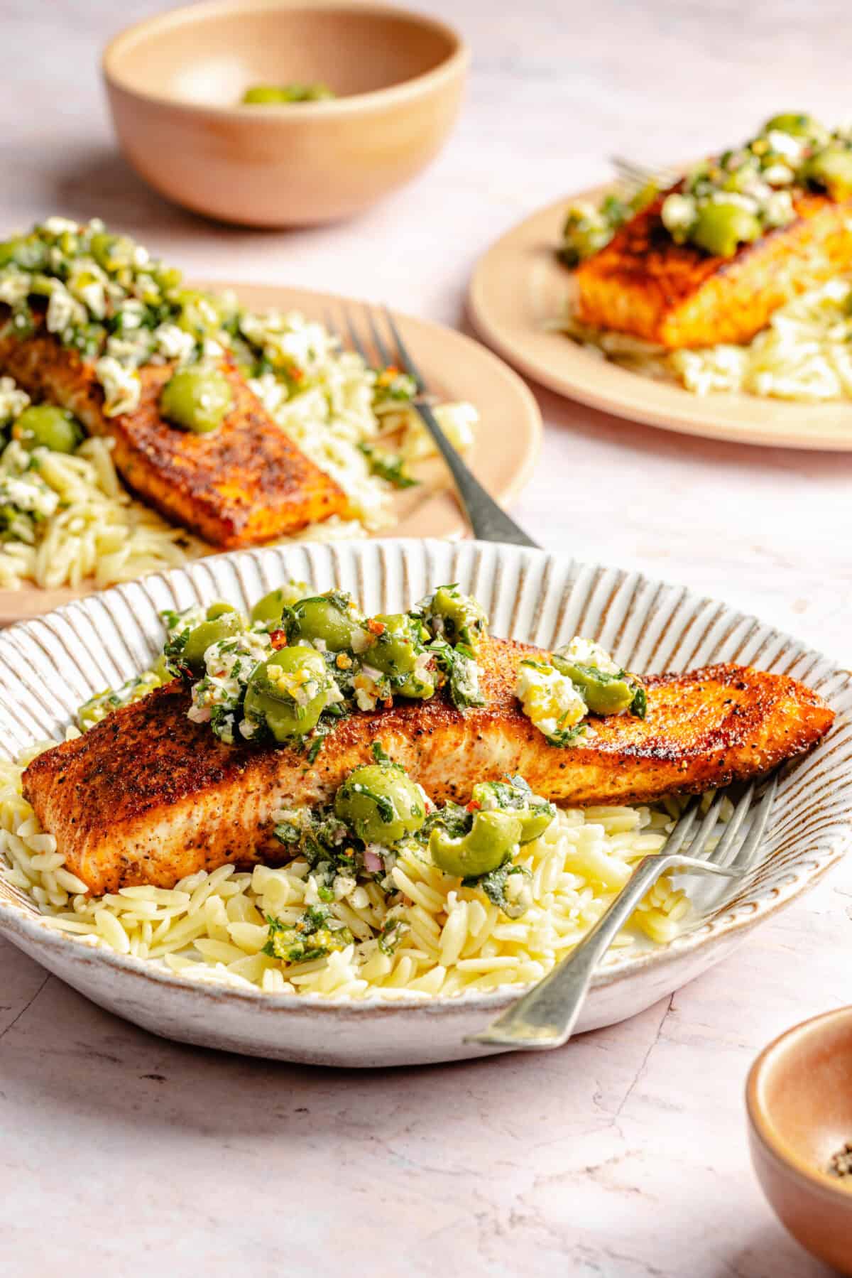 Pan-Seared Salmon with Castelvetrano Olive and Feta Salsa plated with orzo.