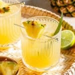 The Flyin' Hawaiian in two glasses on woven tray.
