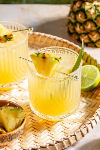 The Flyin' Hawaiian in two glasses on woven tray.