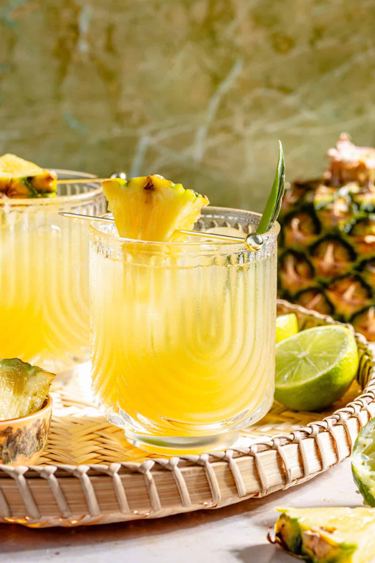 The Kauai Margarita in two glasses on woven tray.
