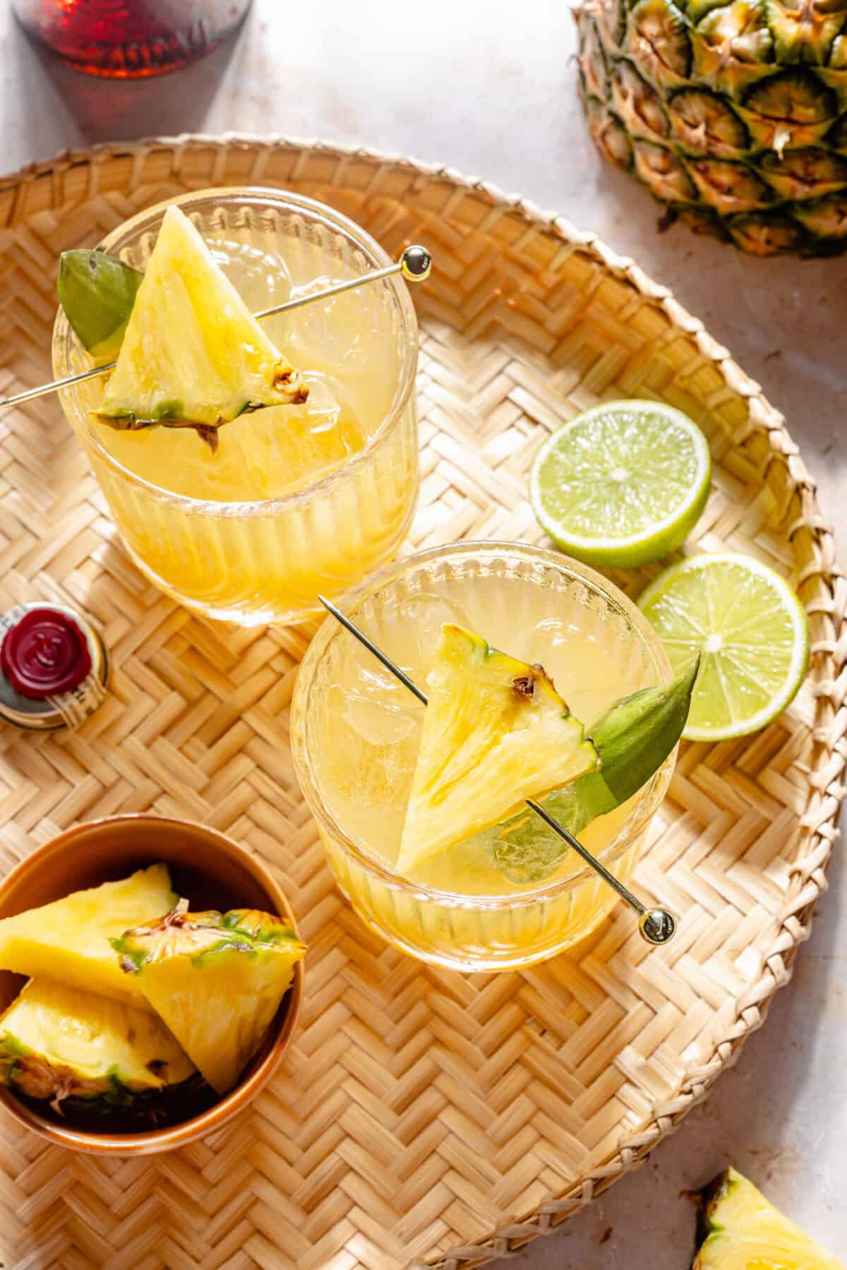 The Kauai Margarita in two glasses on woven tray.