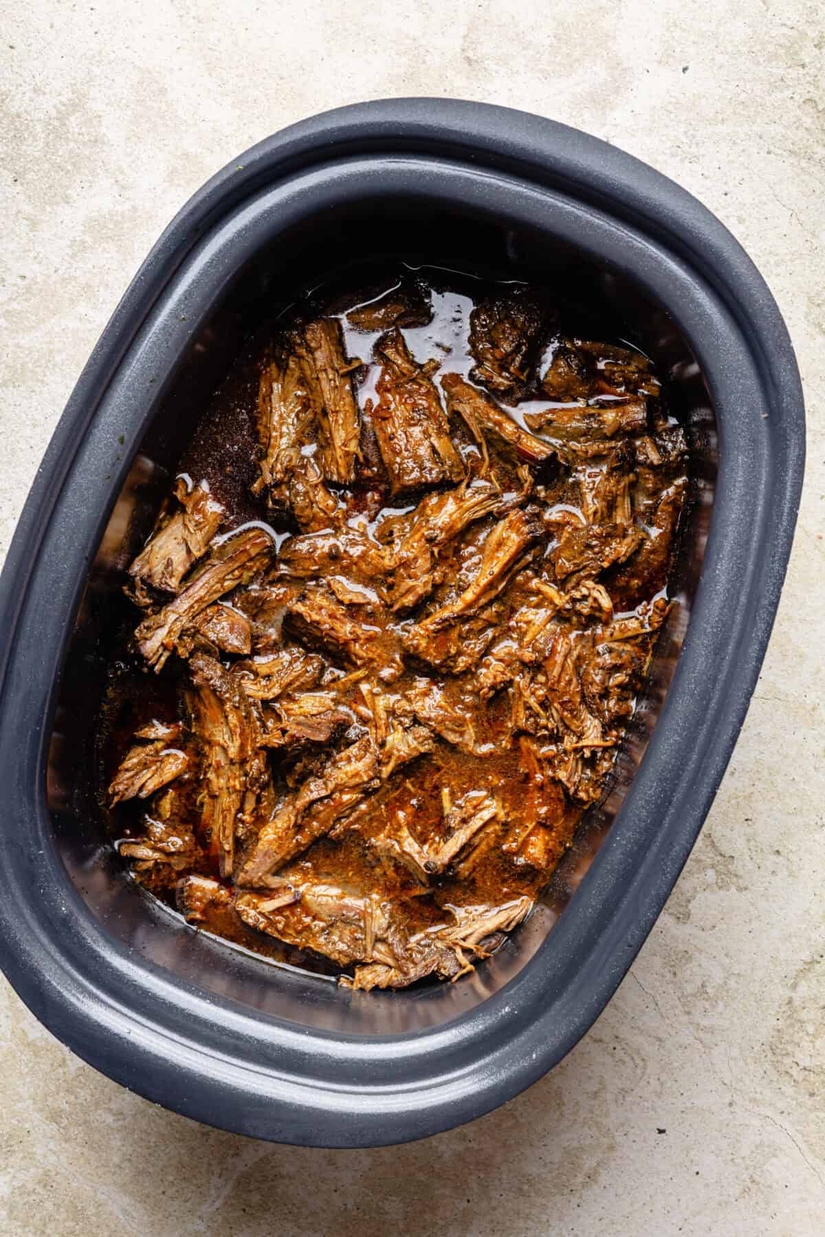 Slow Cooker Miso-Ginger Chuck Roast shredded and cooked in slow cooker.