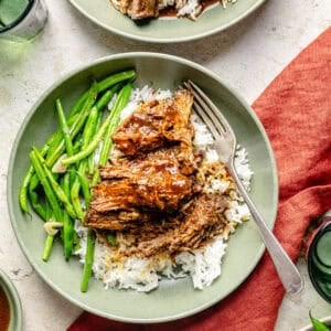 Slow Cooker Miso-Ginger Chuck Roast in a bowl over rice with green beans.