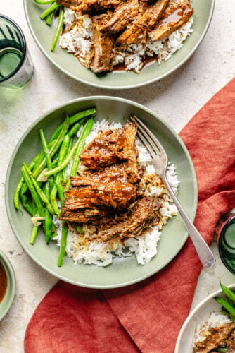Slow Cooker Miso-Ginger Chuck Roast in a bowl over rice with green beans.
