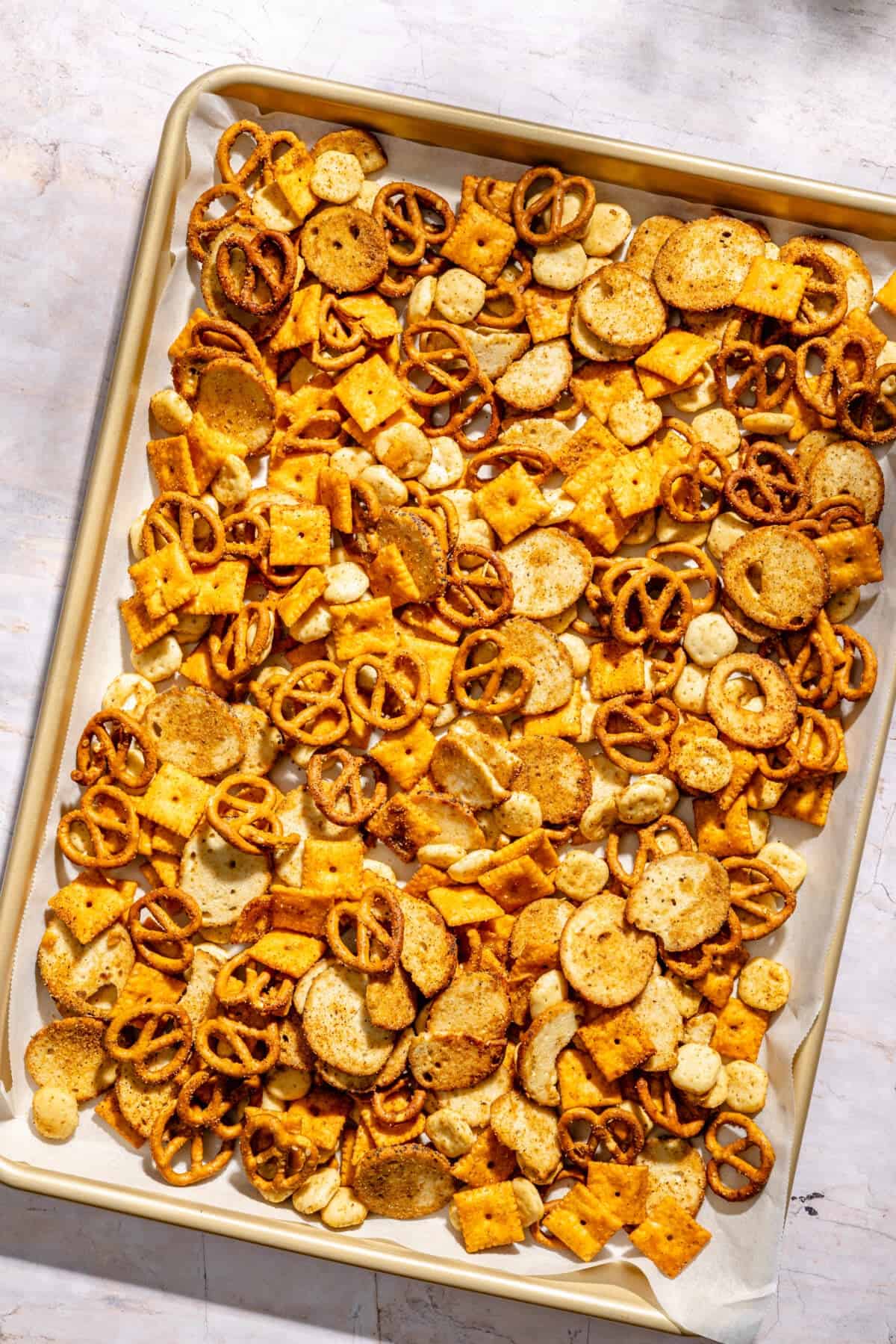 Cajun Cheddar Snack Mix on sheet pan before baking.