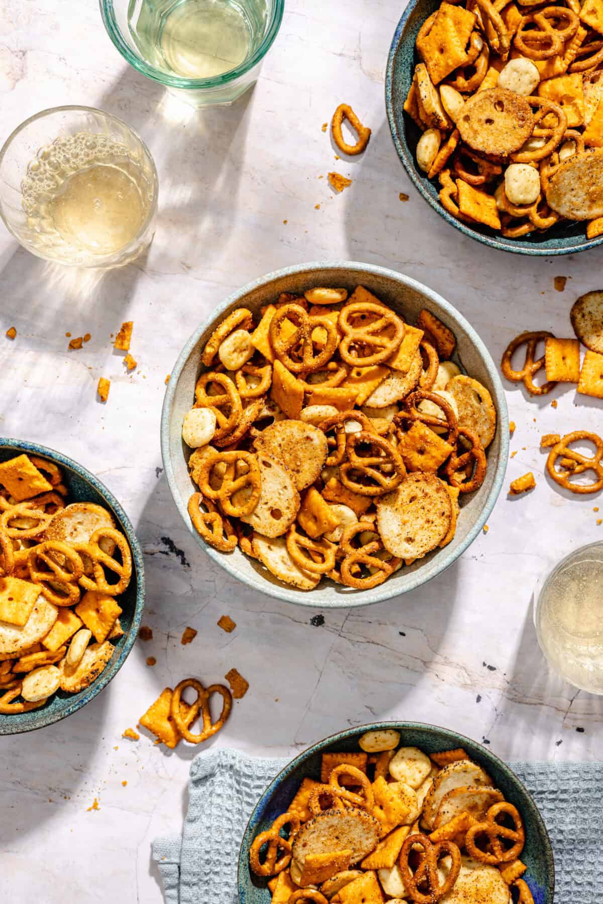 Cajun Cheddar Snack Mix in various serving bowls.