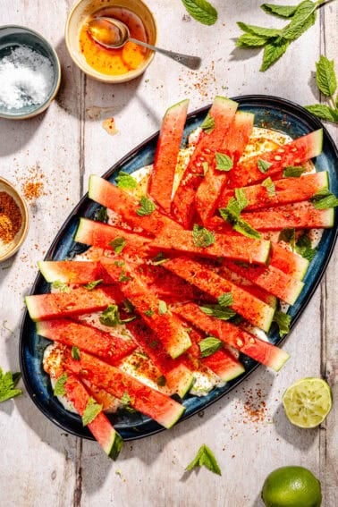 Chili Lime Watermelon with Labneh and Hot Honey on blue platter.