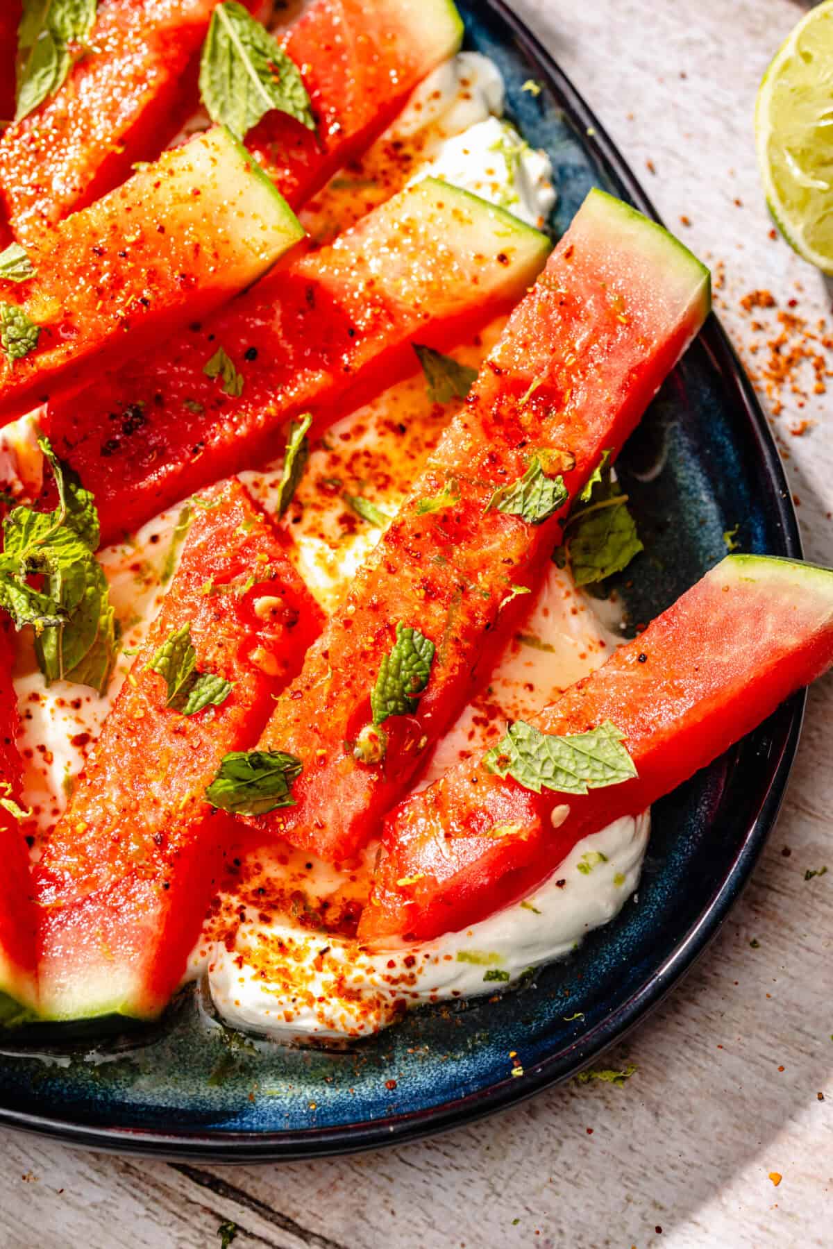 Chili Lime Watermelon with Labneh and Hot Honey on blue platter.
